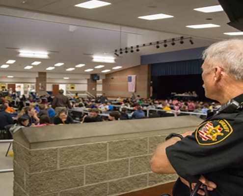 School resource officer watches students