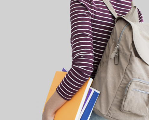 Student with books and a backpack